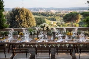 Wedding table set up decorated with with roses and lemon.