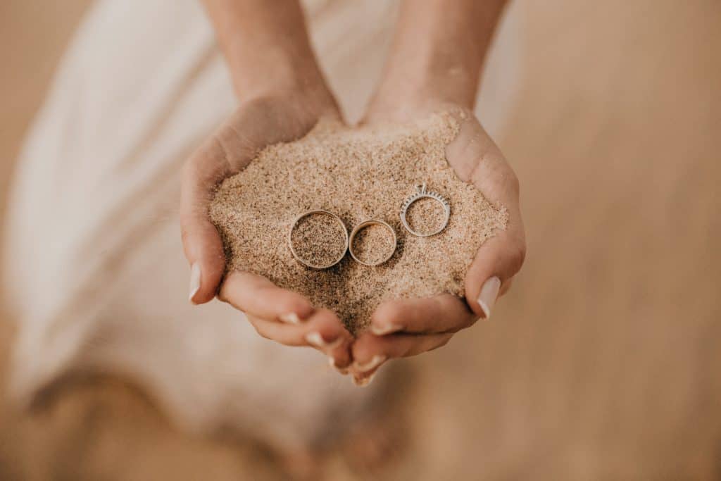Beach Wedding in Itali, rings laid on the sand 