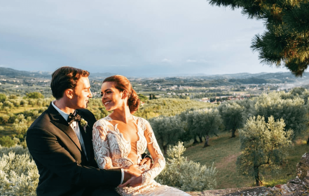 Bride and groom looking at each other with Tuscan Vineyard as background