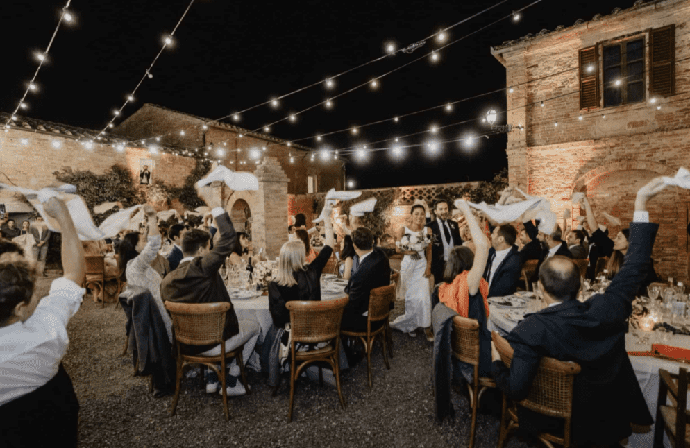 Guests waving napkins when bride and groom make their entrance at the reception