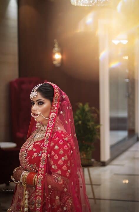 hindu bride in red sari dress during her wedding