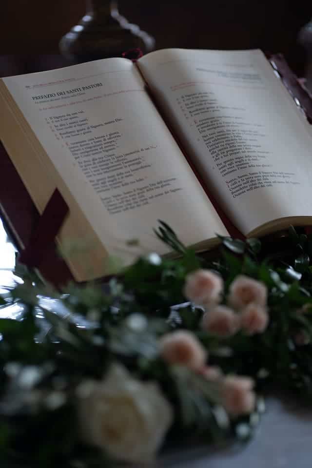 catholic marriage book in a bookrest and flowers
