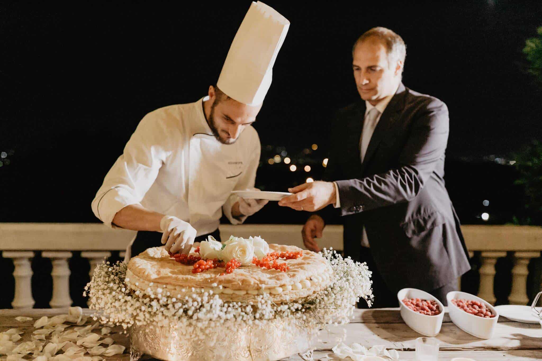 Chef is cutting an Italian wedding Millefoglie Cake