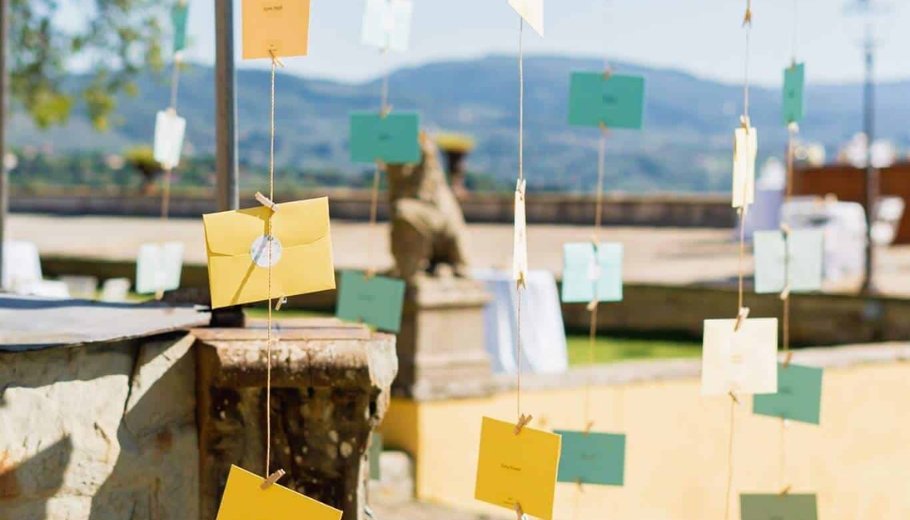 Outdoor wedding ceremony featuring colorful notes, with guests gathered to celebrate the couple's special day.