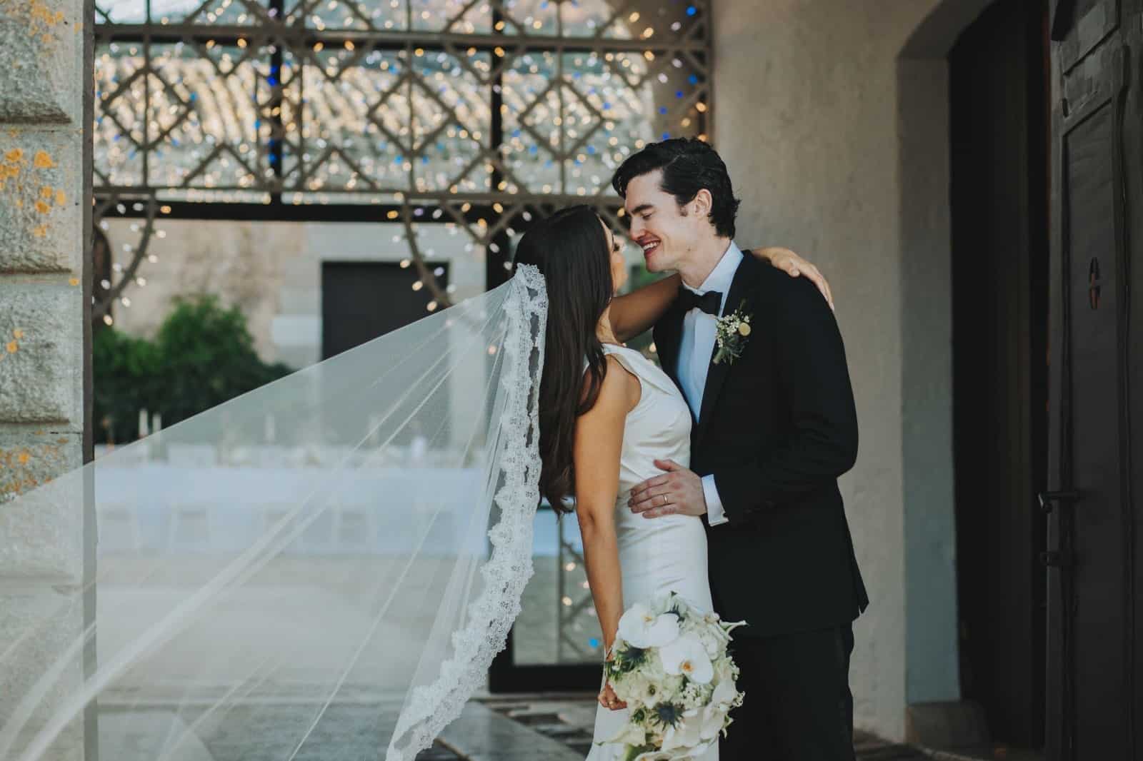 Spouses Ariana and Jack kiss each other at their sicilian wedding