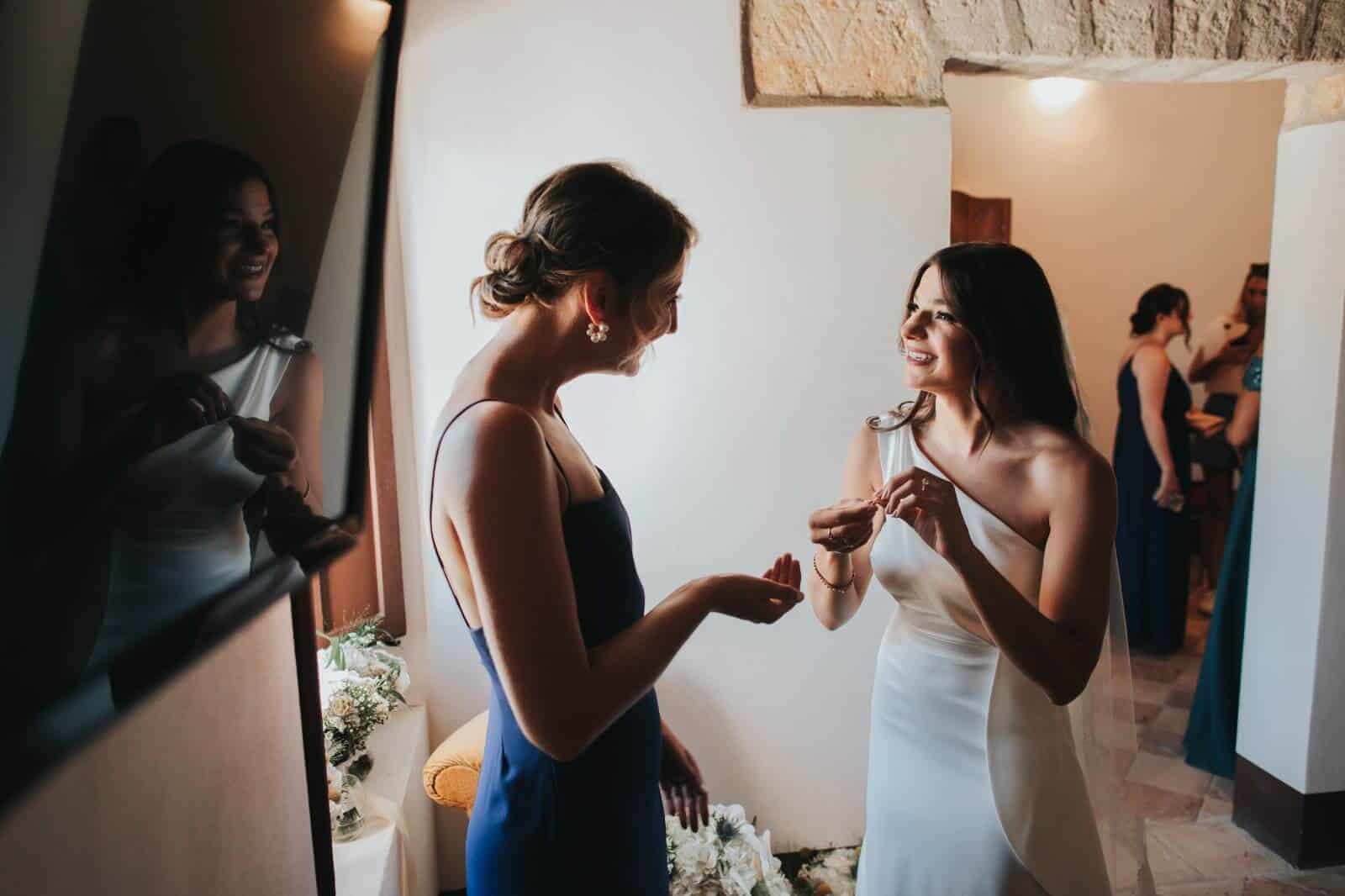 Maid of honor talk with bride during make up