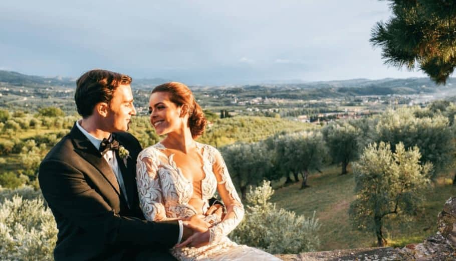 Bride and groom looking at each other with beautiful Tuscan Vineyard as background